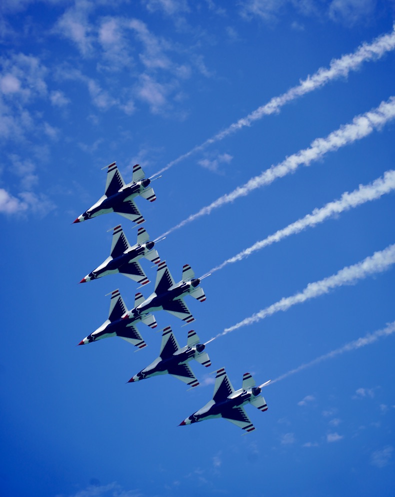 Blue Angels formation cutting through the sky.